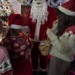 Mikołaj z pomocnikiem rozdają upominki